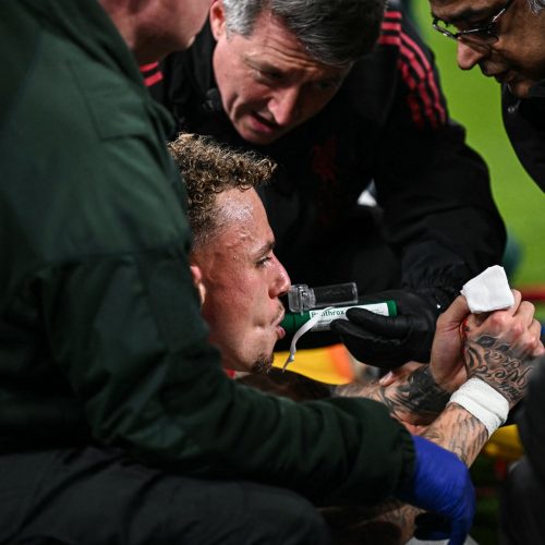 Galatasaray's Dutch forward #77 Noa Lang receives medical attention after cutting his thumb during the UEFA Champions League, round of 16 second leg football match between Liverpool and Galatasaray at Anfield in Liverpool, north-west England on March 18, 2026. (Photo by Paul ELLIS / AFP)