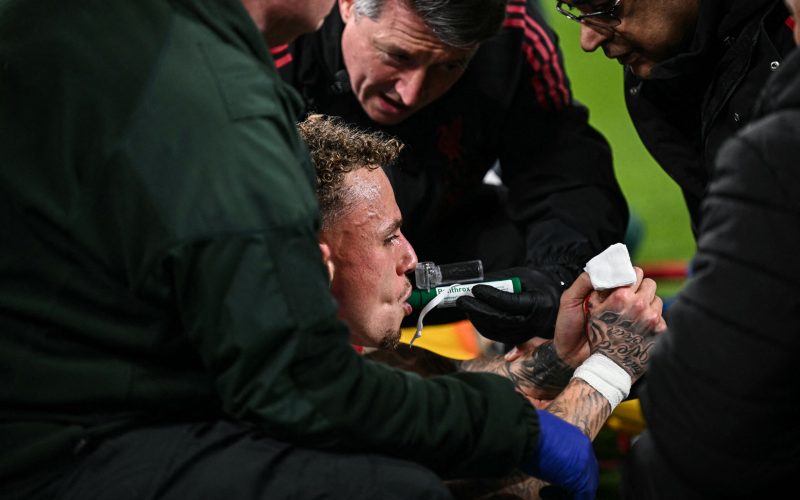 Galatasaray's Dutch forward #77 Noa Lang receives medical attention after cutting his thumb during the UEFA Champions League, round of 16 second leg football match between Liverpool and Galatasaray at Anfield in Liverpool, north-west England on March 18, 2026. (Photo by Paul ELLIS / AFP)